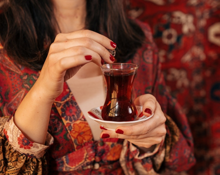 Turkish Girl is holding a Cup of Turkish Tea