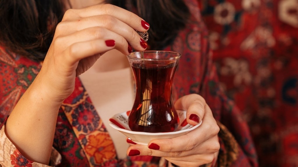 Woman sipping traditional Turkish tea – exploring the side effects of Turkish tea.
