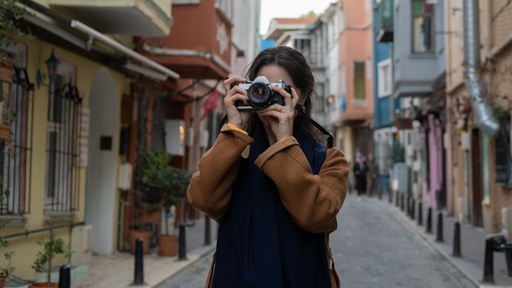 Tourist Etiquette in Turkey - traveler respectfully taking photos in Istanbul street, highlighting cultural awareness, photography manners, and proper behavior for visitors in Turkey.